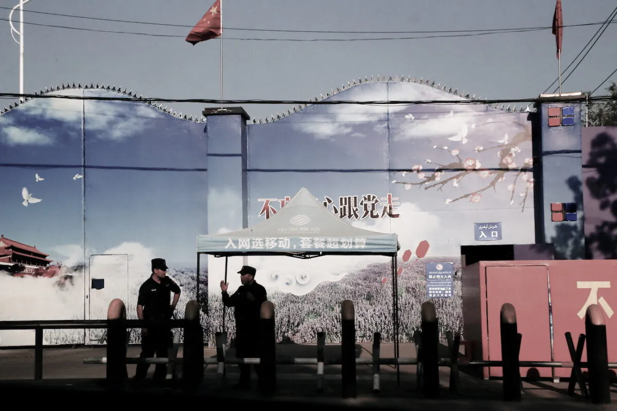 Security guards stand at the gates of what is officially known as a vocational skills education center in Huocheng County in Xinjiang Uyghur Autonomous Region, China, on Sept. 3, 2018. (Thomas Peter/Reuters)