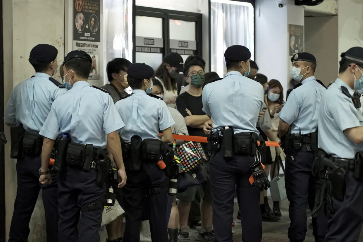 Police officers stop and search residents at Mong Kok district on the 32nd anniversary of suppression on pro-democracy demonstrators at Beijing's Tiananmen Square in 1989, in Hong Kong, on June 4, 2021. (Pak Yiu/Reuters)