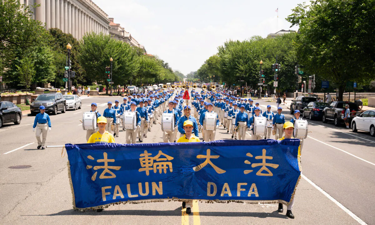 Falun Gong practitioners take part in a parade marking the 22nd anniversary of the start of the Chinese regime's persecution of Falun Gong, in Washington on July 16, 2021. (Larry Dye/The Epoch Times)
