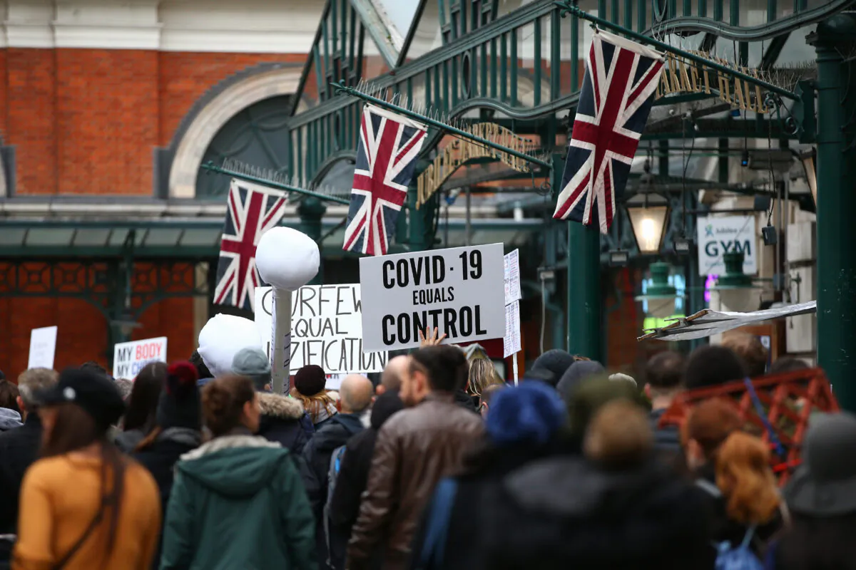 Demonstrators march through Covent Garden during a StandUpX March for Freedom protest in London, England, on Oct. 17, 2020. (Hollie Adams/Getty Images)