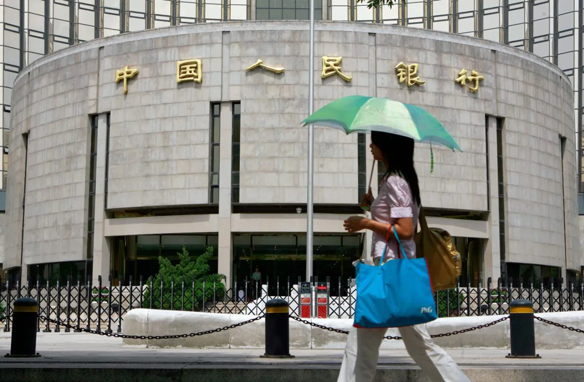 A pedestrian walks past the People's Bank of China, China's Central Bank, in Beijing in a file photo. (Teh Eng Koon/AFP via Getty Images)