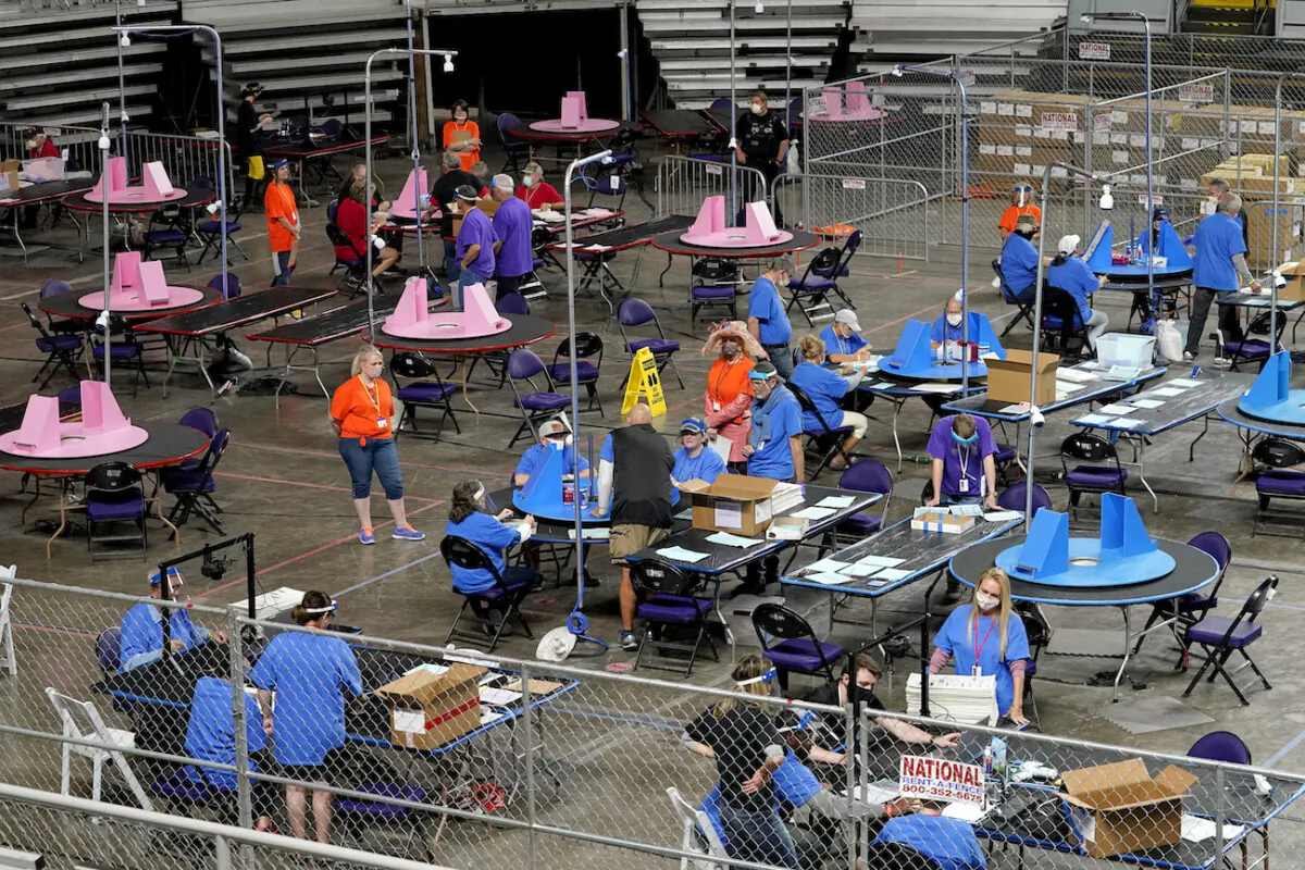 Maricopa County ballots cast in the 2020 general election are examined and recounted by contractors working for Florida-based company, Cyber Ninjas at Veterans Memorial Coliseum in Phoenix, Arizona, on May 6, 2021. (AP Photo/Matt York, Pool)
