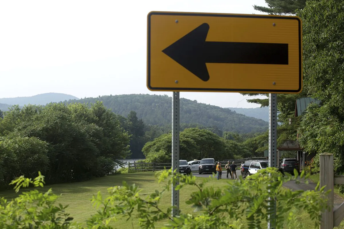 Investigators, including those from the Federal Aviation Administration, gather along the Connecticut River and Route 25 in Bradford, Vt., on July 16, 2021. (Geoff Hansen/The Valley News via AP)