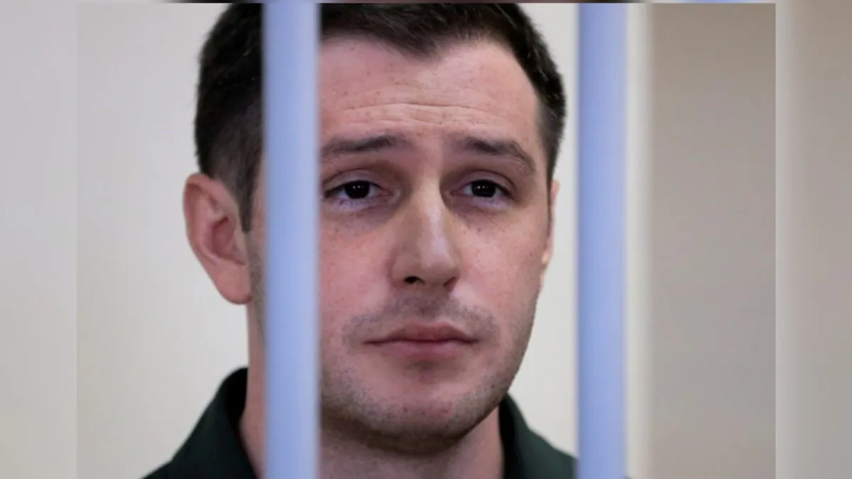 U.S. ex-Marine Trevor Reed stands inside a defendants' cage during a court hearing in Moscow, Russia, on March 11, 2020. (Tatyana Makeyeva/File/Reuters)
