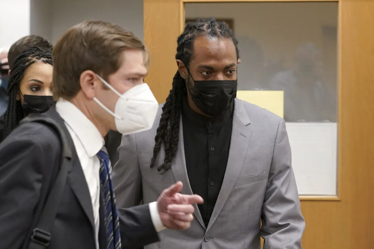 NFL football player Richard Sherman (R) heads into a hearing at King County District Court with his attorney Cooper Offenbecher, in Seattle, Wash., on July 16, 2021. (Ted S. Warren/AP Photo)