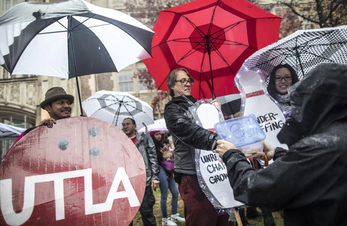 Teachers, students, friends and family protest and picket in the pouring rain outside John Marshall High School during a United Teachers Los Angeles strike in Los Angeles, Calif., on Jan. 14, 2019. (Barbara Davidson/Getty Images)