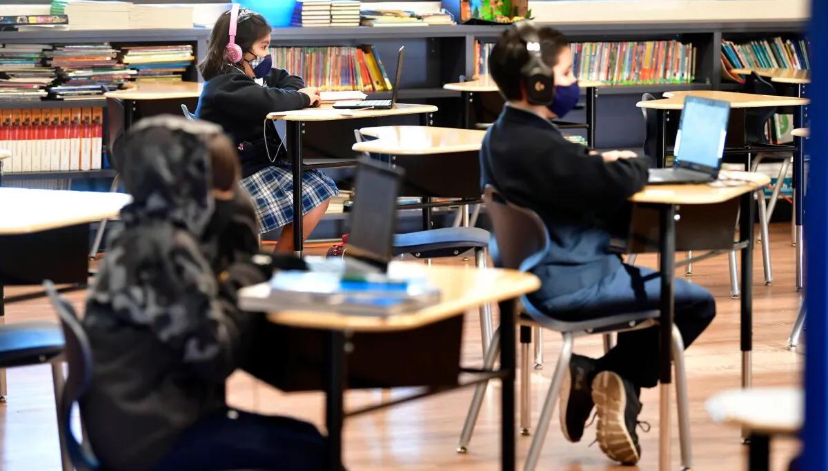Students sit with their laptop computers in a classroom in La Puente, Calif., on Nov. 16, 2020. (Frederic J. Brown/AFP via Getty Images)
