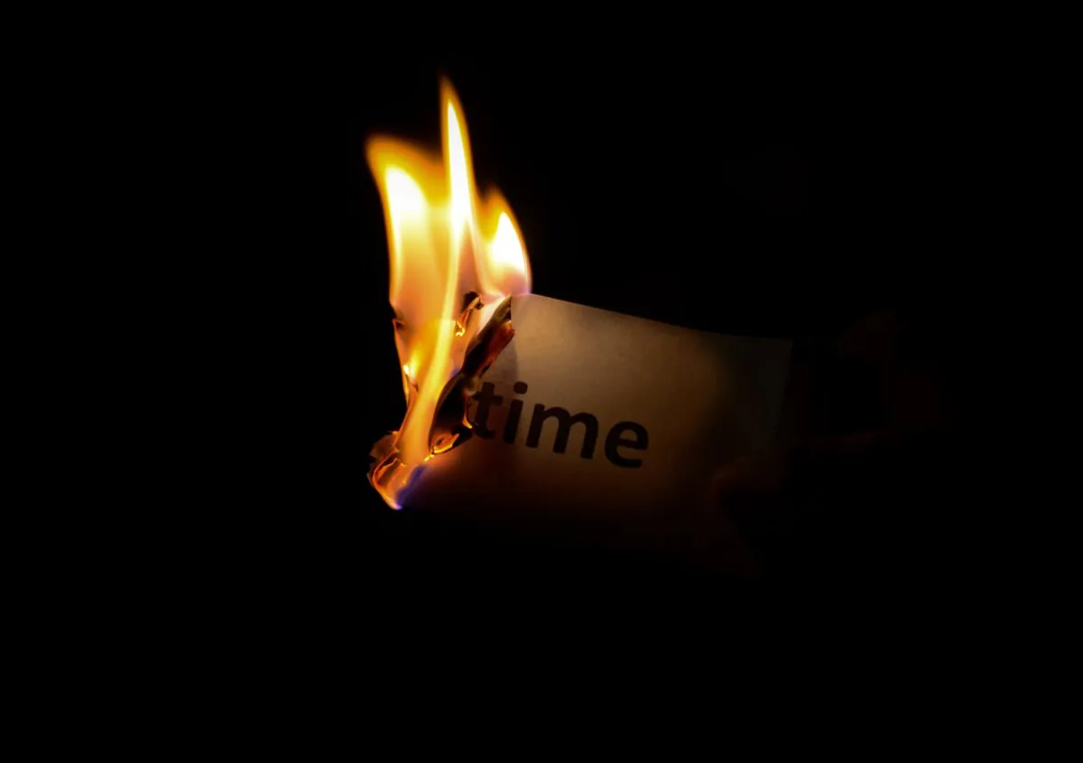 The word time can be seen on a piece of paper that is burning, illustrating managing the time. (Pexels/Pixabay)