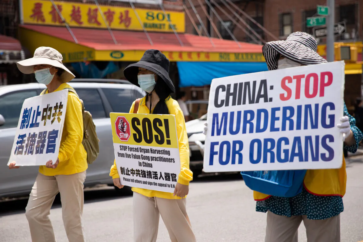 Falun Gong practitioners take part in a parade marking the 22nd year of the persecution of Falun Gong in China, in New York on July 18, 2021. (Chung I Ho/The Epoch Times)
