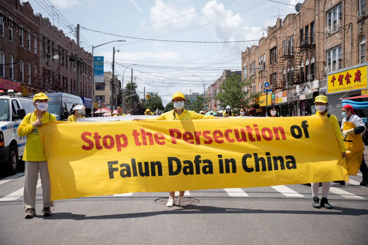 Falun Gong practitioners take part in a parade marking the 22nd year of the persecution of Falun Gong in China, in Brooklyn, N.Y., on July 18, 2021. (Chung I Ho/The Epoch Times)