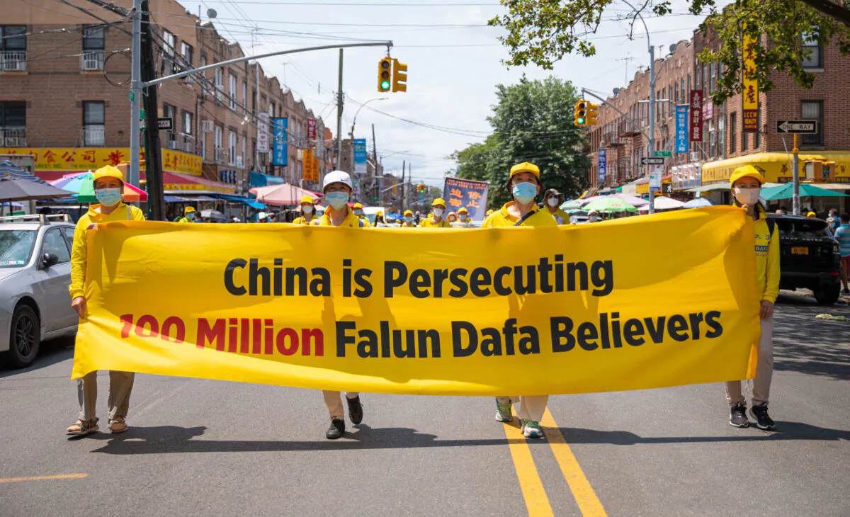 Falun Gong practitioners take part in a parade marking the 22nd year of the persecution of Falun Gong in China, in Brooklyn, N.Y., on July 18, 2021. (Chung I Ho/The Epoch Times)