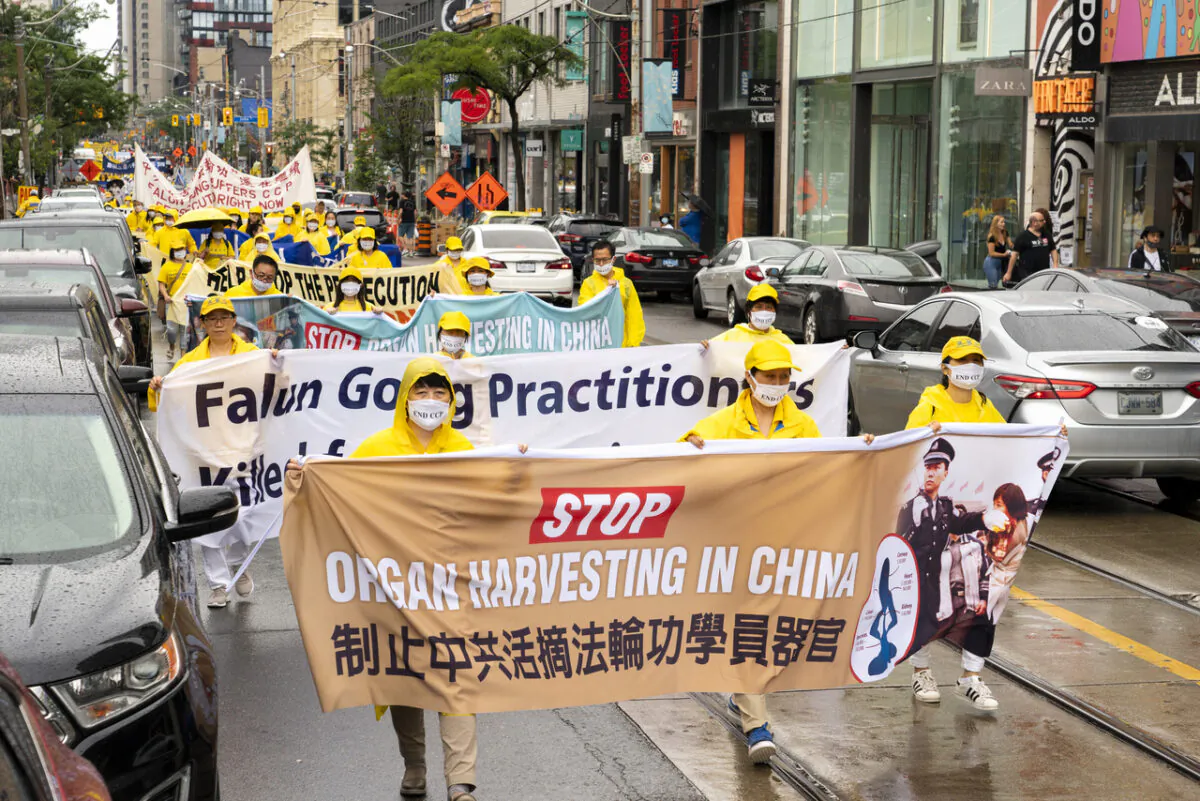 Falun Gong adherents parade through downtown Toronto on July 17, 2021, marking 22 years since Chinese Communist Party launched its campaign of persecution against the spiritual practice in China. (Evan Ning/The Epoch Times)