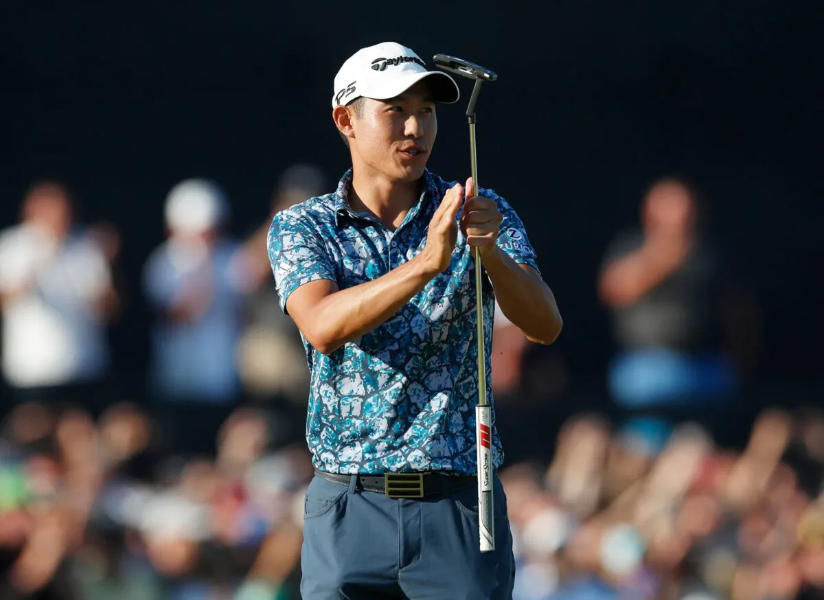 Collin Morikawa of the United States celebrates after holing his putt on the 18th green to win the British Open Golf Championship at Royal St George's golf course in Sandwich, England, on July 18, 2021. (Paul Childs/Reuters)