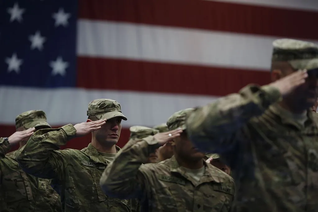 Soldiers from the U.S. Army's 3rd Brigade Combat Team, 1st Infantry Division, salute during the playing of the Star-Spangled Banner during a homecoming ceremony in the Natcher Physical Fitness Center in Fort Knox, Kentucky on Feb. 27, 2014. (Luke Sharrett/Getty Images)