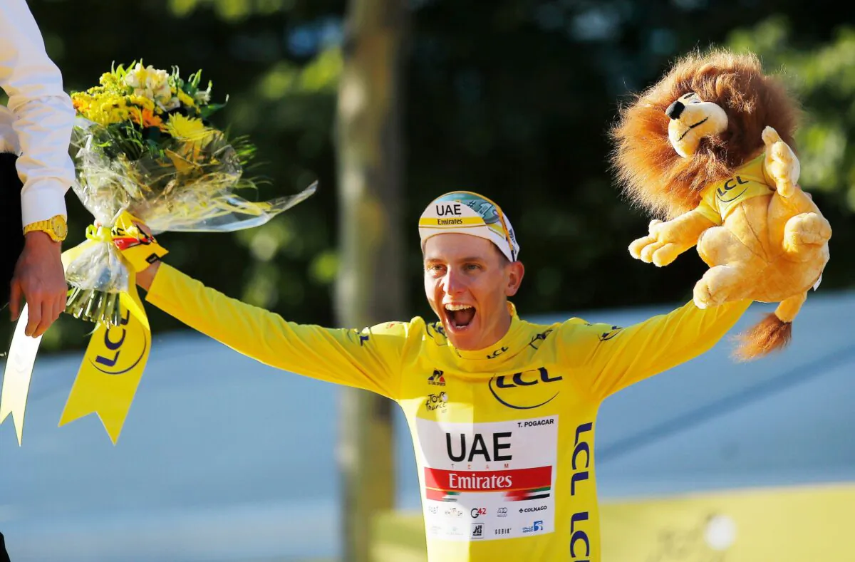 UAE Team Emirates rider Tadej Pogacar of Slovenia celebrates on the podium after winning the yellow jersey and the Tour de France, Cycling, in France, on July 18, 2021. (Stephane Mahe/Reuters)