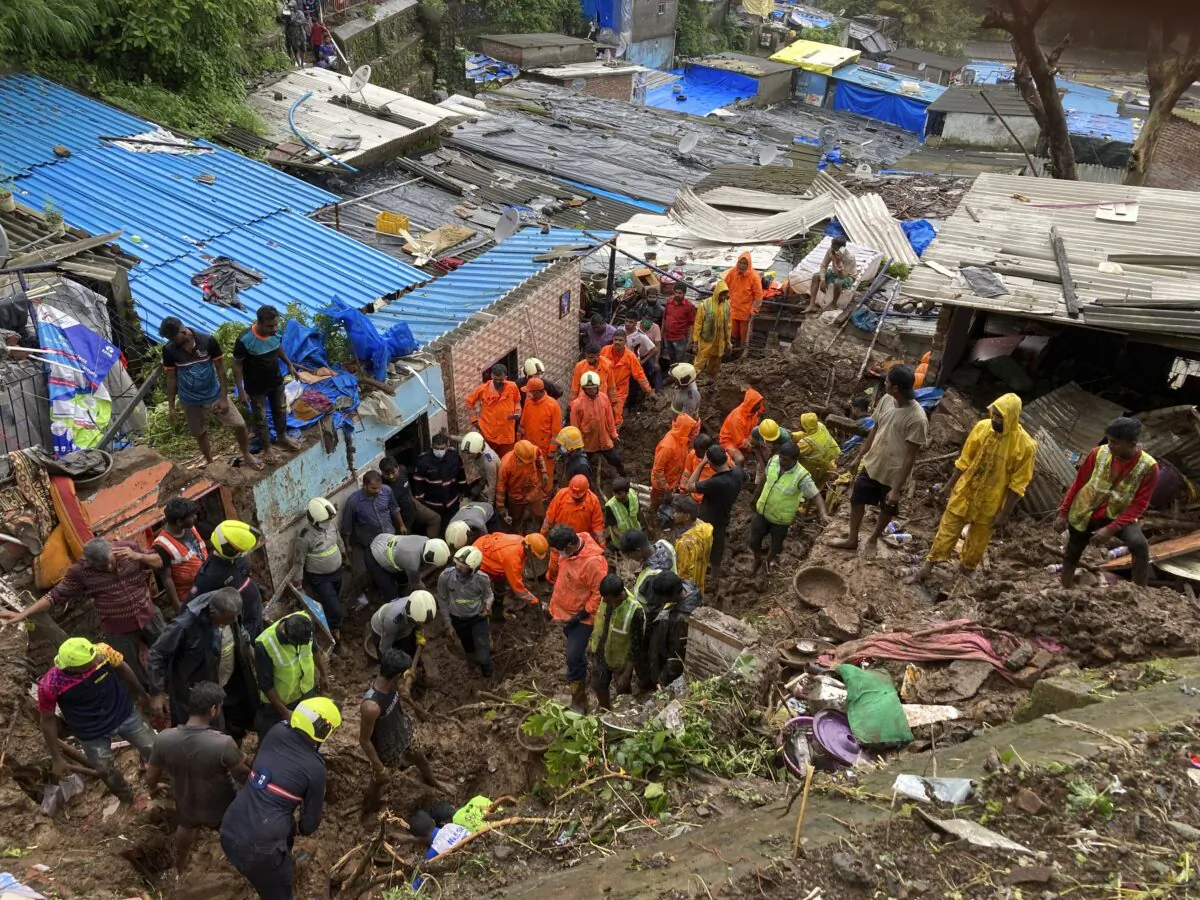 Rescuers look for survivors after a wall collapsed on several slum houses heavy monsoon rains in the Mahul area of Mumbai, India, on July 18, 2021. (Rajanish Kakade/AP Photo)