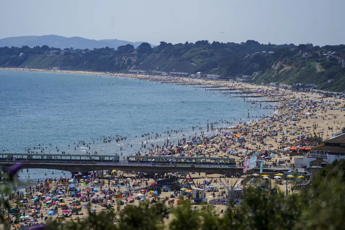 People enjoy the weather on Bournemouth beach in Dorset, Britain, on July 19, 2021. (Steve Parsons/PA)