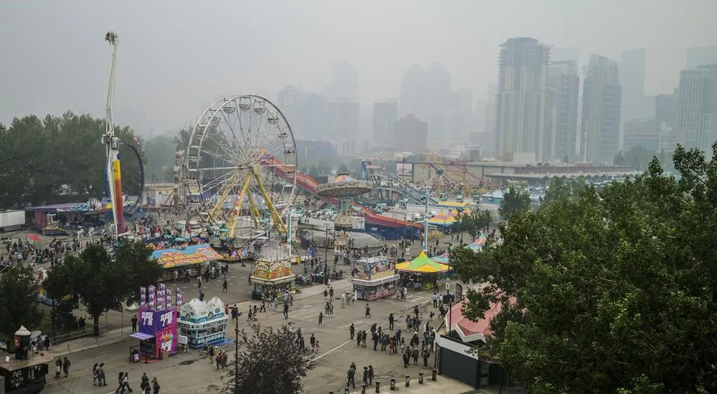 Visitors to the Stampede had to cope an Air Quality Health Index (AQHI) of ten with wildfire smoke blowing into Calgary, Alta.,  July 18, 2021. (The Canadian Press/Jeff McIntosh)