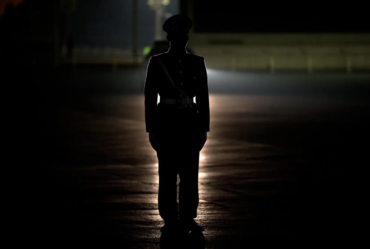A Chinese paramilitary stands guard on Tiananmen Square before a flag raising ceremony in Beijing on March 17, 2013. (AP Photo/Andy Wong)