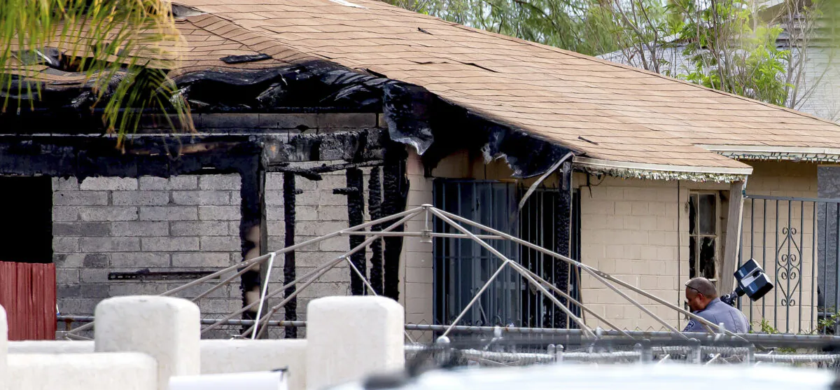Tucson Police investigators work at the scene of a house fire where a body was found in Tucson, Ariz., on July 19, 2021. (Rebecca Sasnett/Arizona Daily Star via AP)