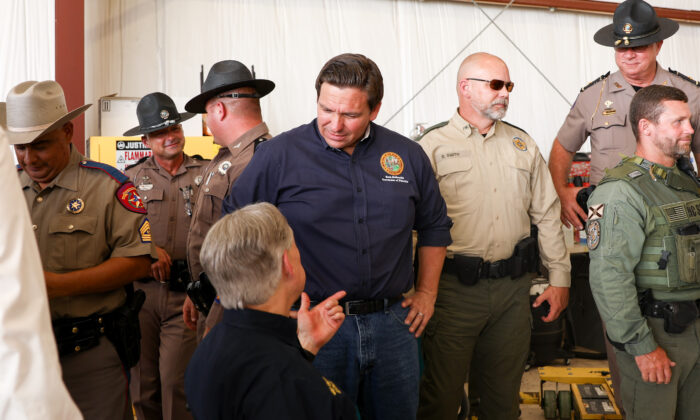 Florida Gov. Ron DeSantis speaks with Texas Gov. Greg Abbott at a border meeting in Del Rio, Texas, on July 18, 2021. (Charlotte Cuthbertson/The Epoch Times)