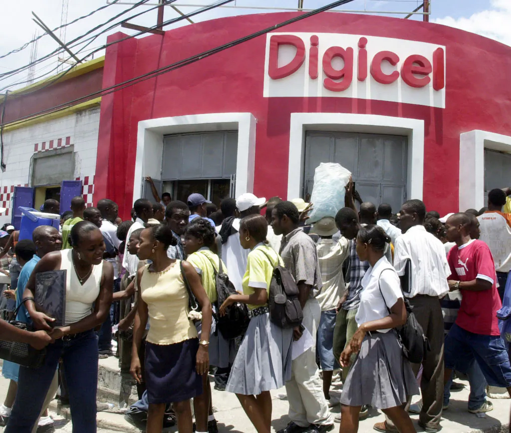Haitians line up 05 May, 2006, at the DIGICEL office in Port-au-Prince to get new cellular phones and service. (Thony Belizaire/AFP via Getty Images)