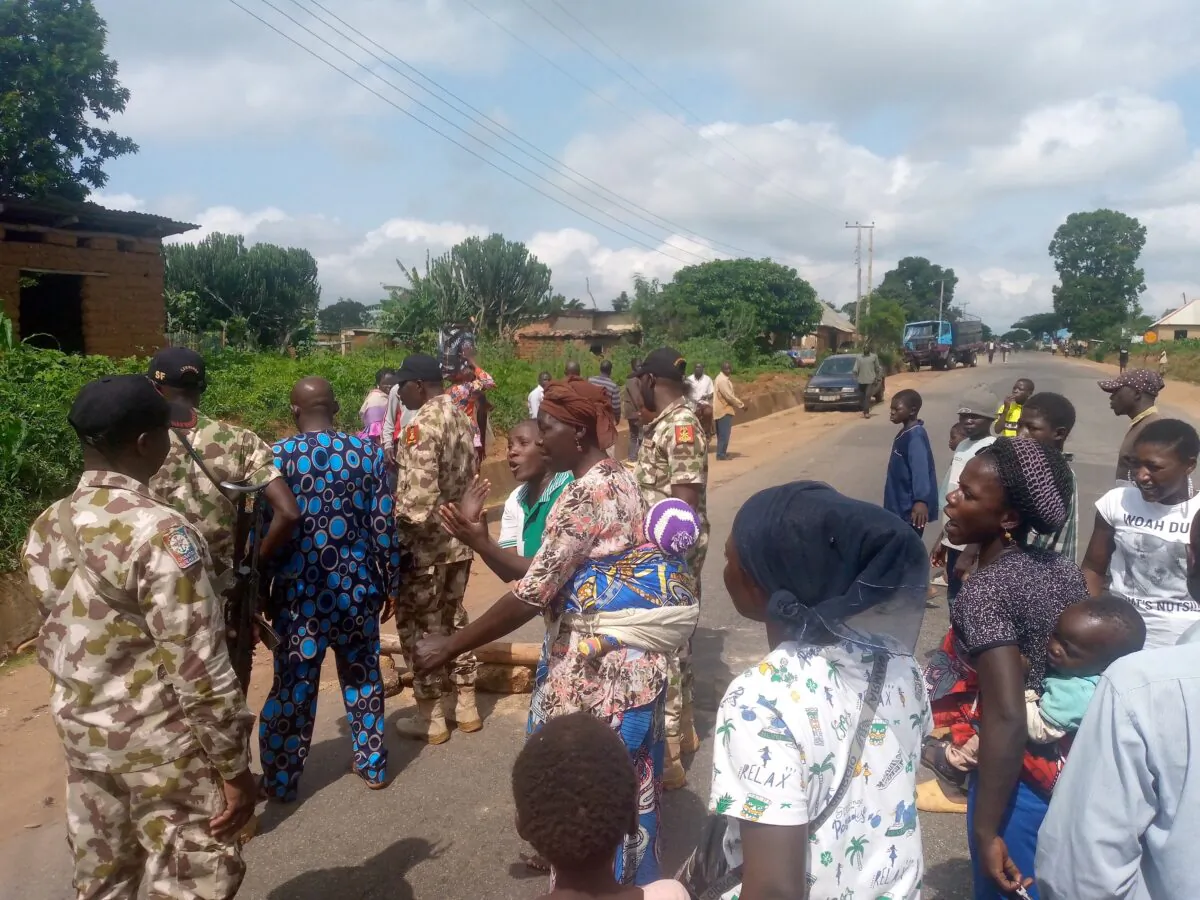 Women and children demand withdrawal of military after alleged shooting of two civilians, in conflict Zone south of Jos, Nigeria, on July 14, 2021. Protestors tell Military Officials who visit protest ground that they no longer trust Army to protect them. Masara Kim
