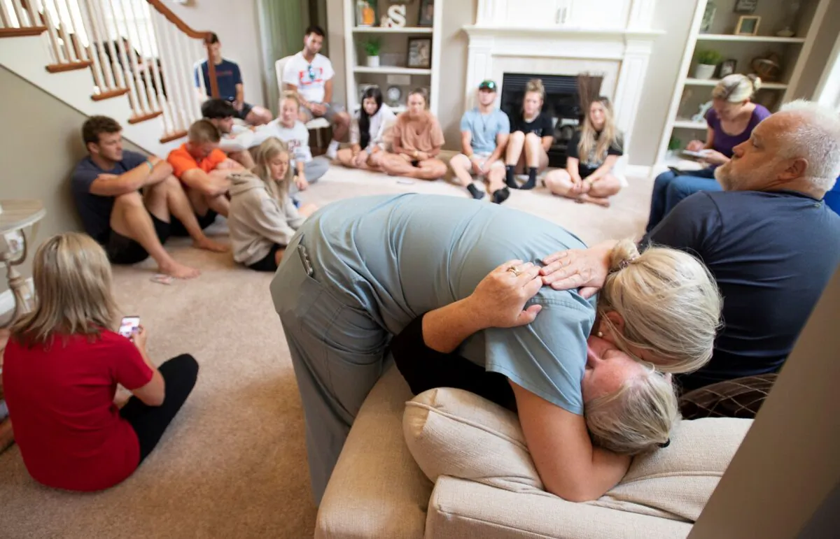 Amy Satterthwaite, the mother of Richie Mays Jr., gets a hug as family and friends gather to remember Kole Sova, Dawson Brown and Mays at the home of Jerry and Meeka Sova near Jackson, Mich., on Sunday, July 18, 2021. (J. Scott Park/MLive.com/Jackson Citizen Patriot via AP)

