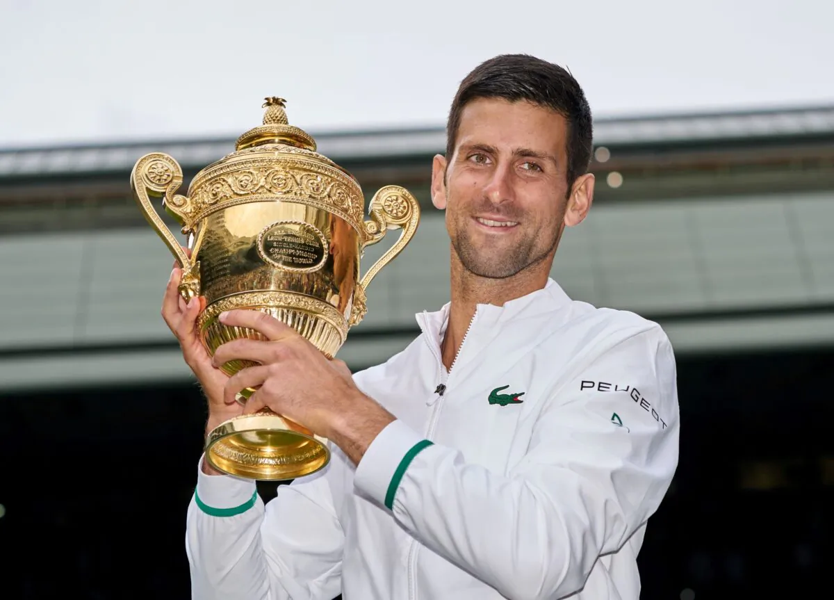 Novak Djokovic of Serbia holds the trophy after beating Matteo Berrettini of Italy in the men's final on Centre Court at The Wimbledon Tennis Championships in London on July 11, 2021. (Peter van den Berg/USA TODAY Sports via Reuters)