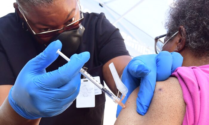 A nurse administers Pfizer's COVID-19 vaccine to a woman in Los Angeles on July 16, 2021. (Frederic J. Brown/AFP via Getty Images)