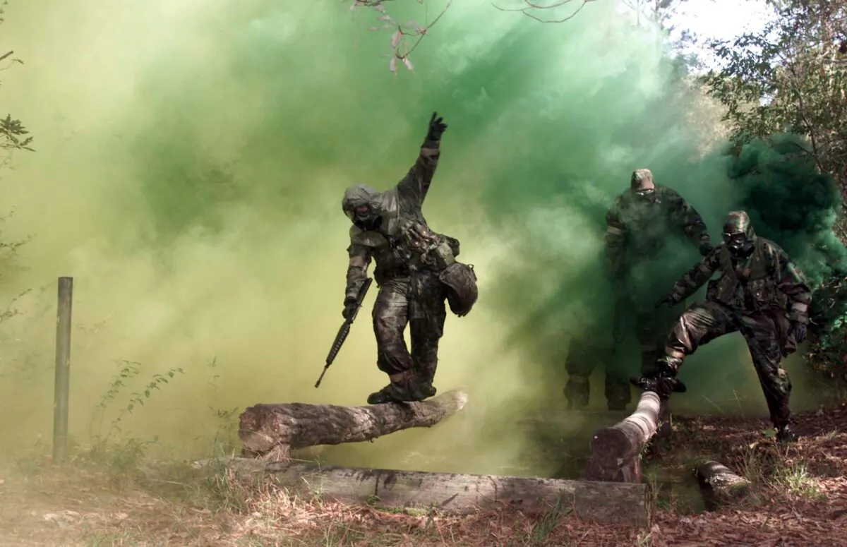 US Marines navigate an obstacle course wearing protective chemical biological gear at Camp Geiger, N.C. on Nov. 1, 2001. (John Althouse/AFP via Getty Images)