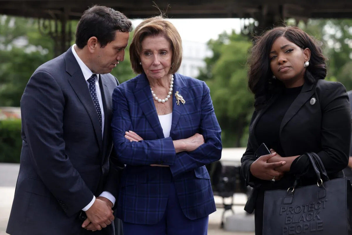 Texas Rep. Trey Martinez Fischer (L), one of the five Texas House Democrats who have tested positive for COVID-19, is seen on Capitol Hill with House Speaker Nancy Pelosi (D-Calif.) (C) in Washington on July 13, 2021. (Alex Wong/Getty Images)