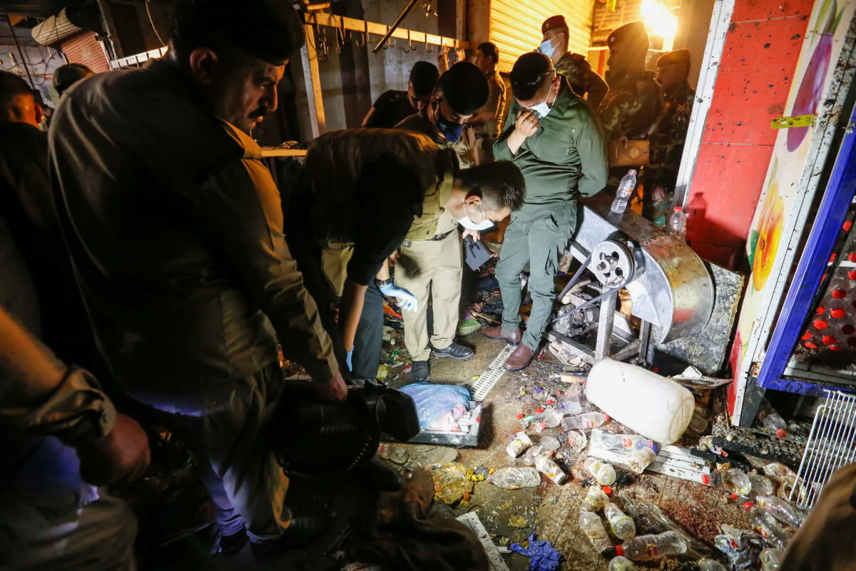 Iraqi security forces inspect the site of an explosion in Sadr City district of Baghdad, Iraq, on July 19, 2021. 
(Wissam Al-Okaili/Reuters)