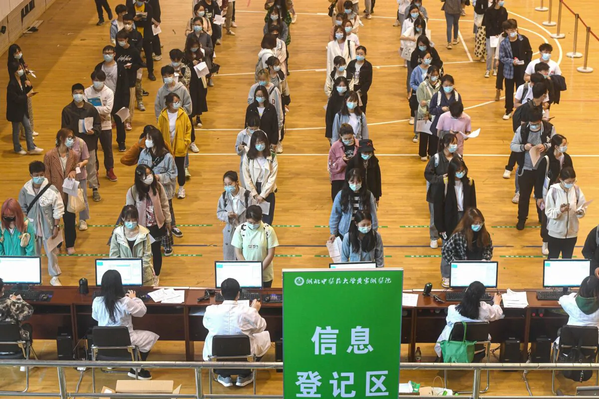 University students queue to receive Covid-19 vaccines at a university in Wuhan, Hubei Province, China, on April 27, 2021. (STR/AFP)