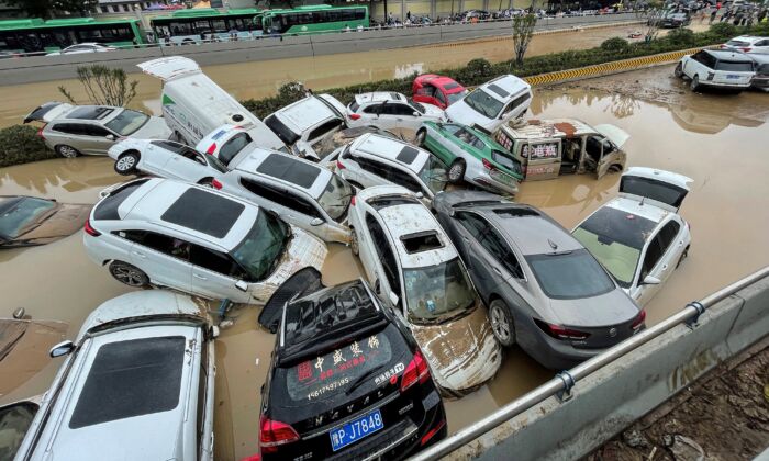 Cars sit in floodwaters after heavy rains hit the city of Zhengzhou in central China's Henan Province on July 21, 2021. (STR/AFP via Getty Images)