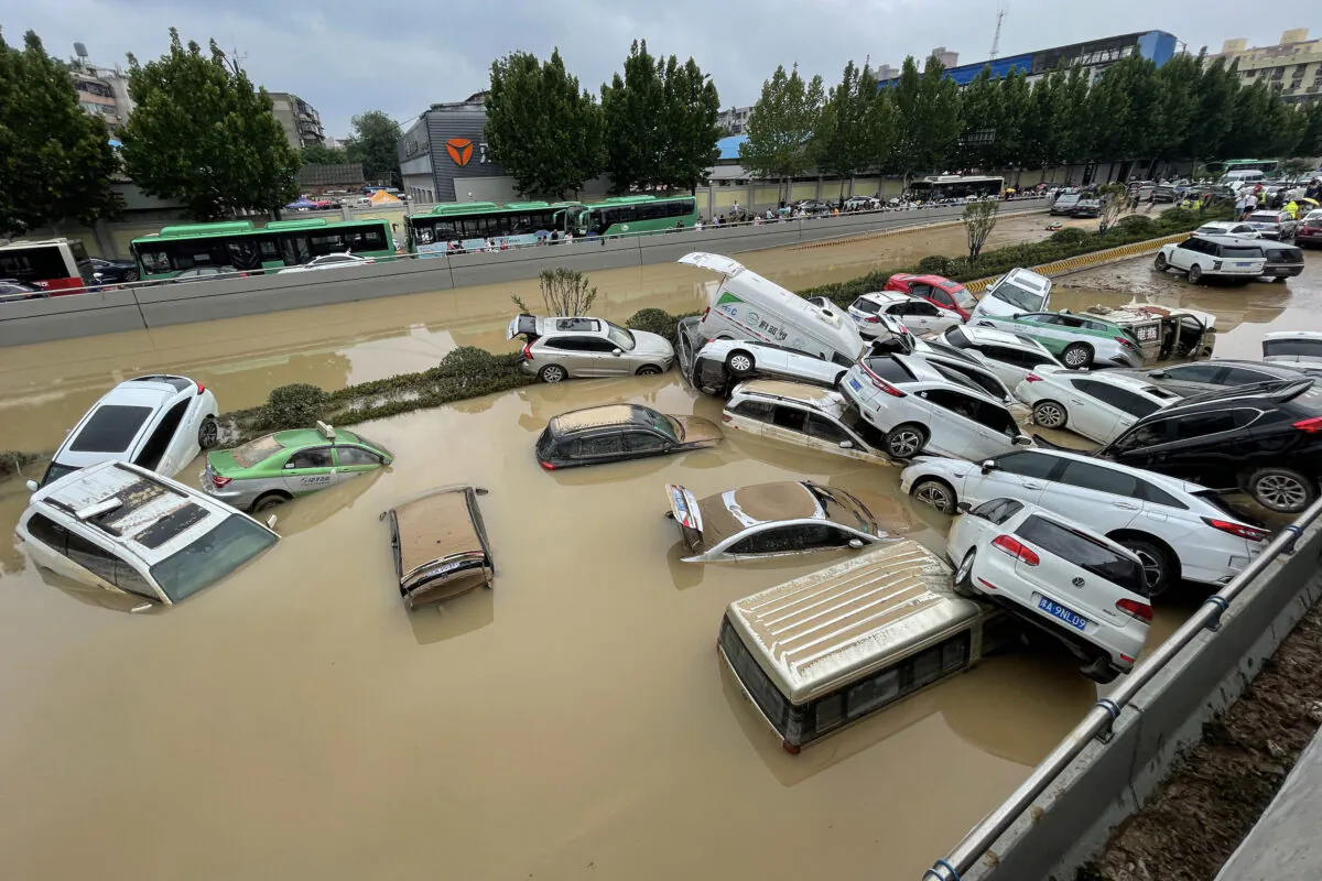 Cars sit in floodwaters after heavy rains hit the city of Zhengzhou in central China's Henan Province on July 21, 2021. (STR/AFP via Getty Images)