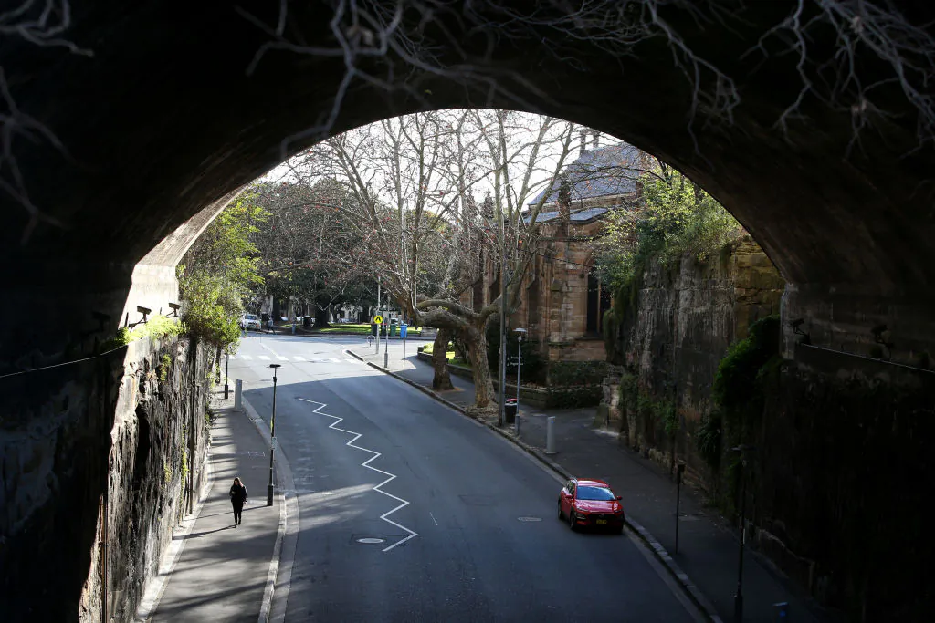 A person walks along a quiet street in the usually bustling area of The Rocks in Sydney, Australia, on July 07, 2021. (Lisa Maree Williams/Getty Images)