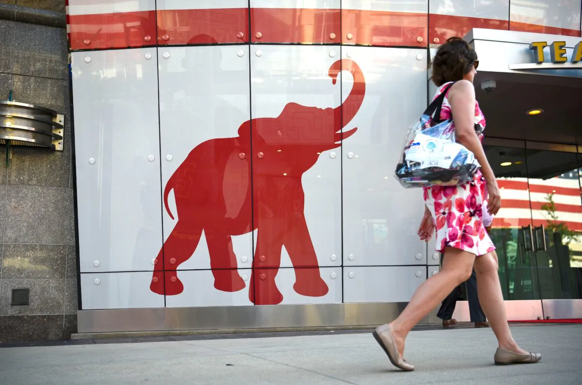 A woman walks past the elephant logo of the Republican Party on the first day of the Republican National Convention in Cleveland, Ohio, on July 18, 2016. (Dominick Reuter/AFP via Getty Images)