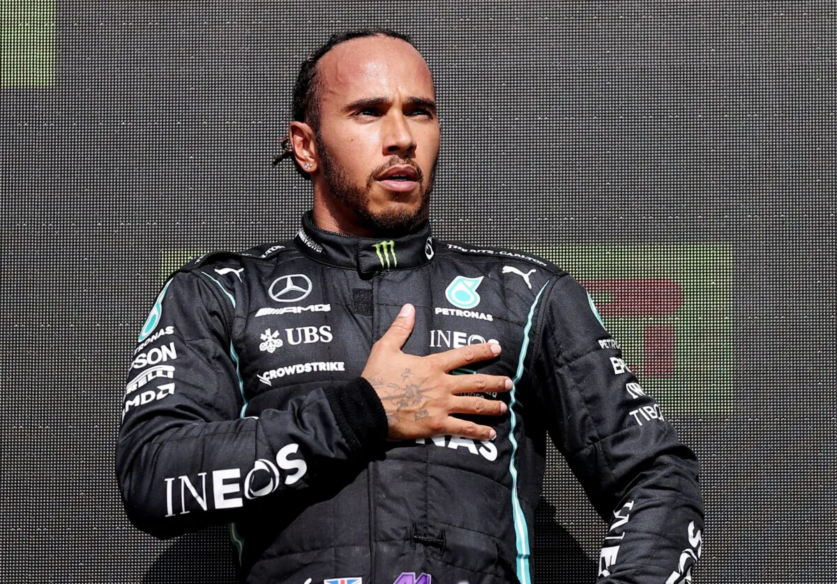 Mercedes' Lewis Hamilton celebrates on the podium after winning the race at British Grand Prix in Silverstone Circuit, Silverstone, Britain on July 18, 2021. (Pool via REUTERS/Lars Baron)
