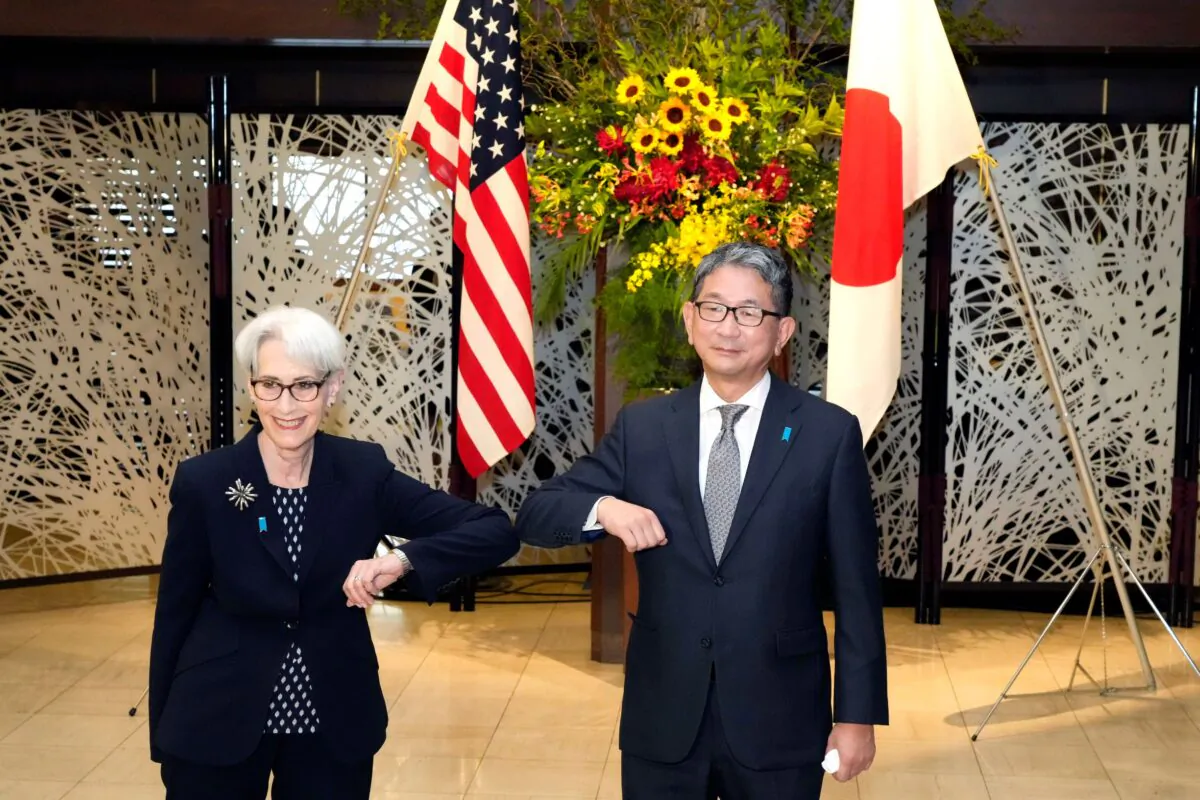 U.S. Deputy Secretary of State Wendy Sherman (L) elbow bumps with Japanese Vice-Minister for Foreign Affairs Takeo Mori (R) prior to their meeting at the Iikura Guesthouse in Tokyo, Japan, on July 20, 2021. (Eugene Hoshiko/AP Photo)