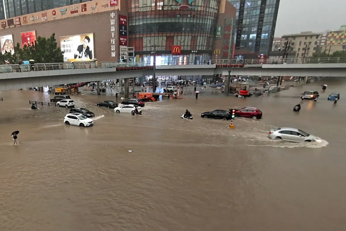 Vehicles are stranded after a heavy downpour in Zhengzhou city, central China's Henan Province on July 20, 2021. (Chinatopix Via AP)