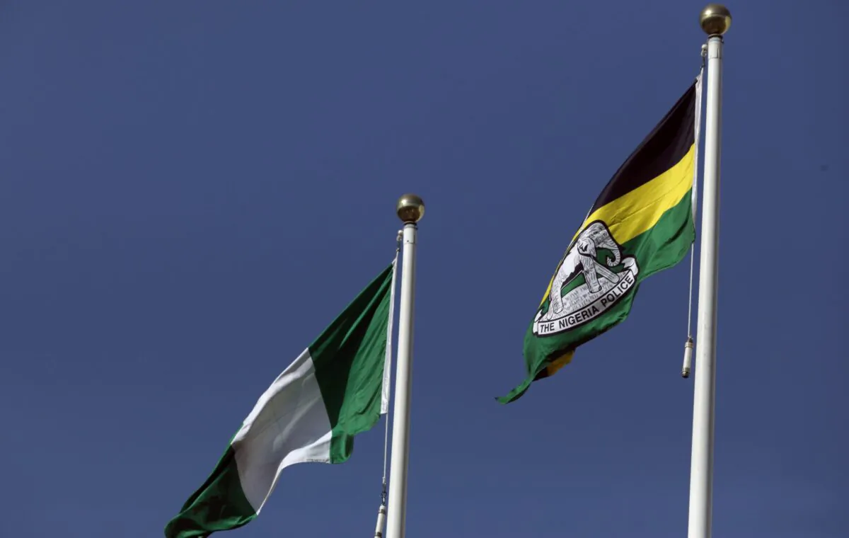 A flag of the Nigeria Police Force flies next to the Nigerian national flag at the Louis Edet House, headquarters of the police in Abuja, Nigeria, on Dec. 5, 2017. (Afolabi Sotunde/Reuters)