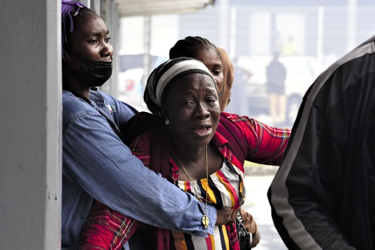 A woman reacts as she doesn't see a relative among the survivors of the sunken cargo ship Niko Ivanka who arrive at John F. Kennedy Memorial Hospital in Monrovia, Liberia, on July 19, 2021. (Carielle Doe/AFP via Getty Images)