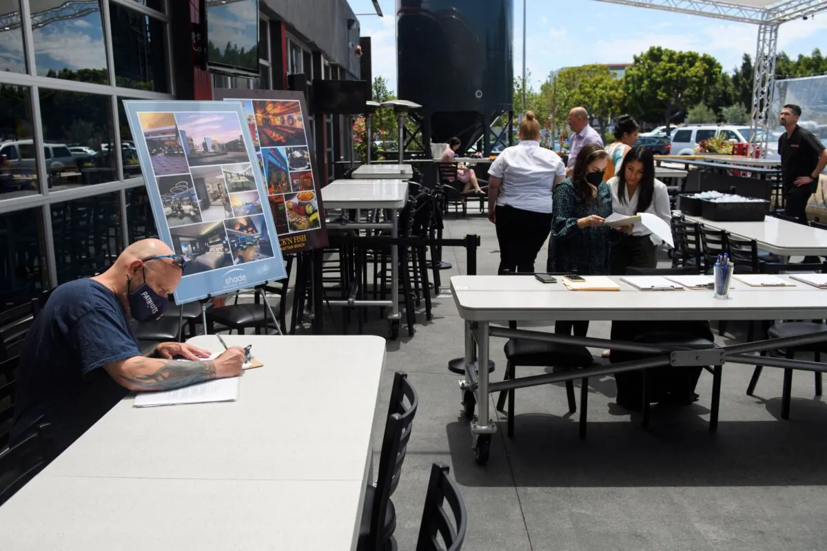 A man completes a job application before interviewing during a Zislis Group job fair at The Brew Hall in Torrance, Calif., on June 23, 2021. (Patrick T. Fallon/AFP via Getty Images)