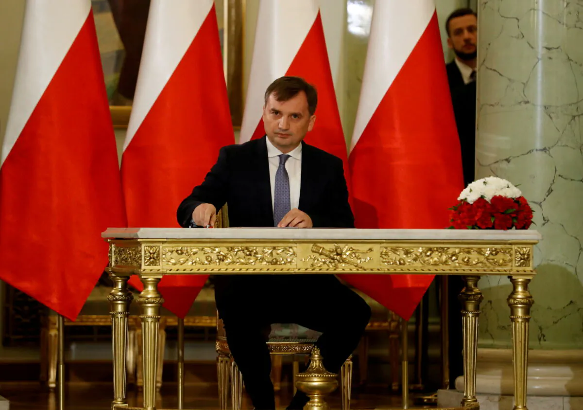 Zbigniew Ziobro signs documents after being designated as Minister of Justice, at the Presidential Palace in Warsaw, Poland, on Nov. 15, 2019. (Kacper Pempel/Reuters)