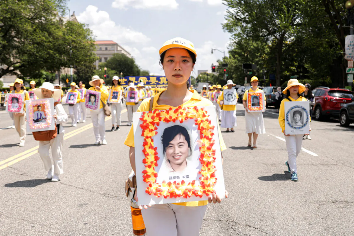 Falun Gong practitioners take part in a parade marking the 22nd anniversary of the start of the Chinese regime’s persecution of Falun Gong in Washington on July 16, 2021. (Samira Bouaou/The Epoch Times)