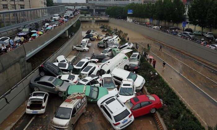 An aerial view shows cars sitting in floodwaters at the entrance of a tunnel after heavy rains hit the city of Zhengzhou, central China's Henan Province on July 22, 2021. (NOEL CELIS/AFP via Getty Images)