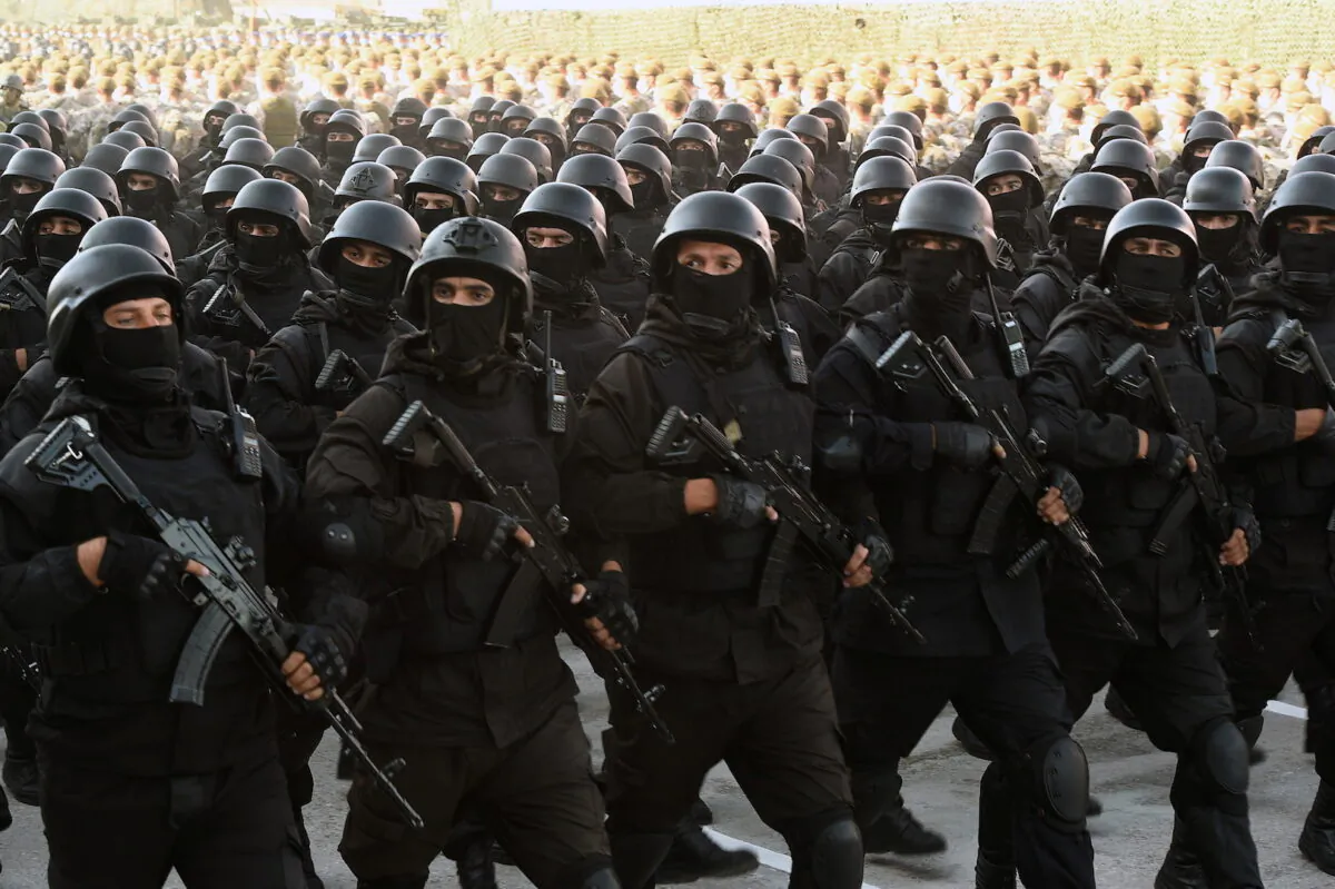 Tajik service members march during a parade following a nationwide military exercise, in Dushanbe, Tajikistan, on July 22, 2021. (Tajik Presidential Press Service/Handout via Reuters)