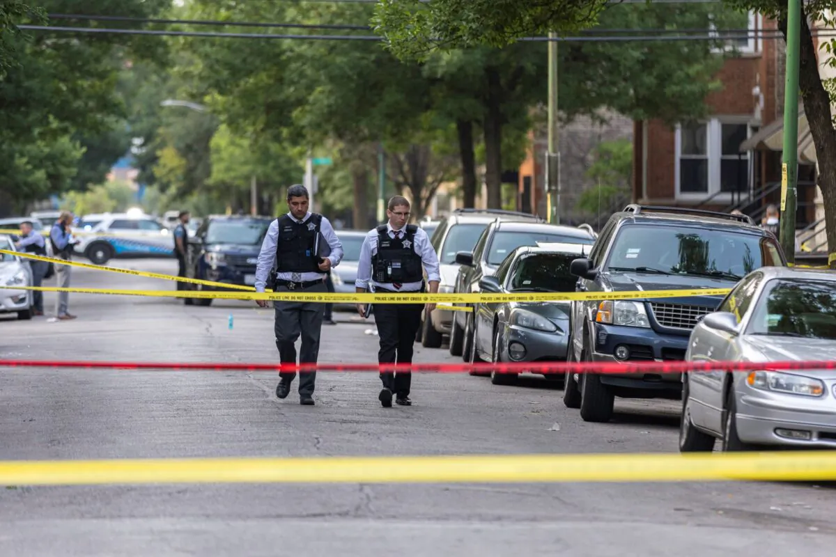 Police investigate the scene of a shooting near 1324 S Christiana Ave in Lawndale, on Chicago’s West Side on July 21, 2021. (Anthony Vazquez/Chicago Sun-Times via AP)