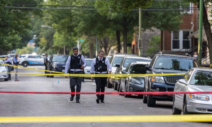 Police investigate the scene of a shooting near 1324 S Christiana Ave in Lawndale, on Chicago’s West Side, Wednesday, July 21, 2021. (Anthony Vazquez/Chicago Sun-Times via AP)
